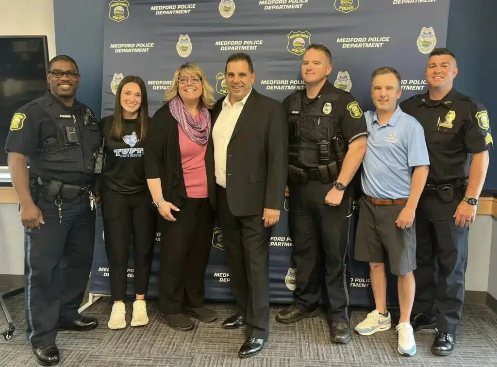Group photo of officers that saved man's life with him and his wife